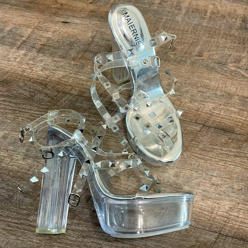 Brand new. Silver and clear high heels.